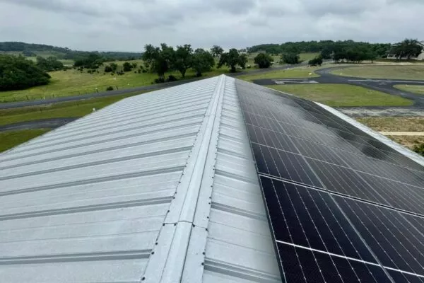 A metal roof with solar panels, showcasing roofing and solar in Austin TX.