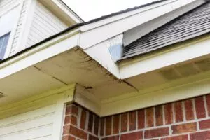 A close up of a roof with damage in need of Kyle roofing services.