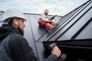 Image of two workers preparing the roof for the Holidays.