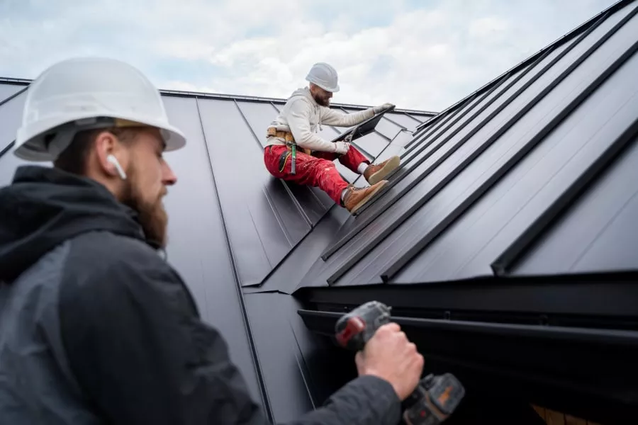 Image of two workers preparing the roof for the Holidays.