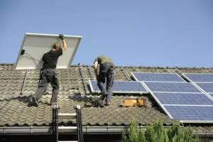 A team of Austin roofers installing solar for businesses in Austin.