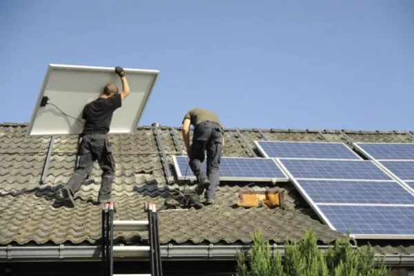 A team of Austin roofers installing solar for businesses in Austin.