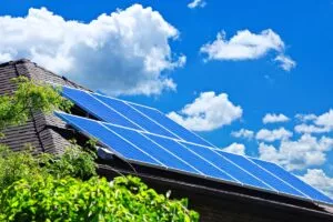 Bastrop solar roofing panels on a house under a blue sky with clouds.