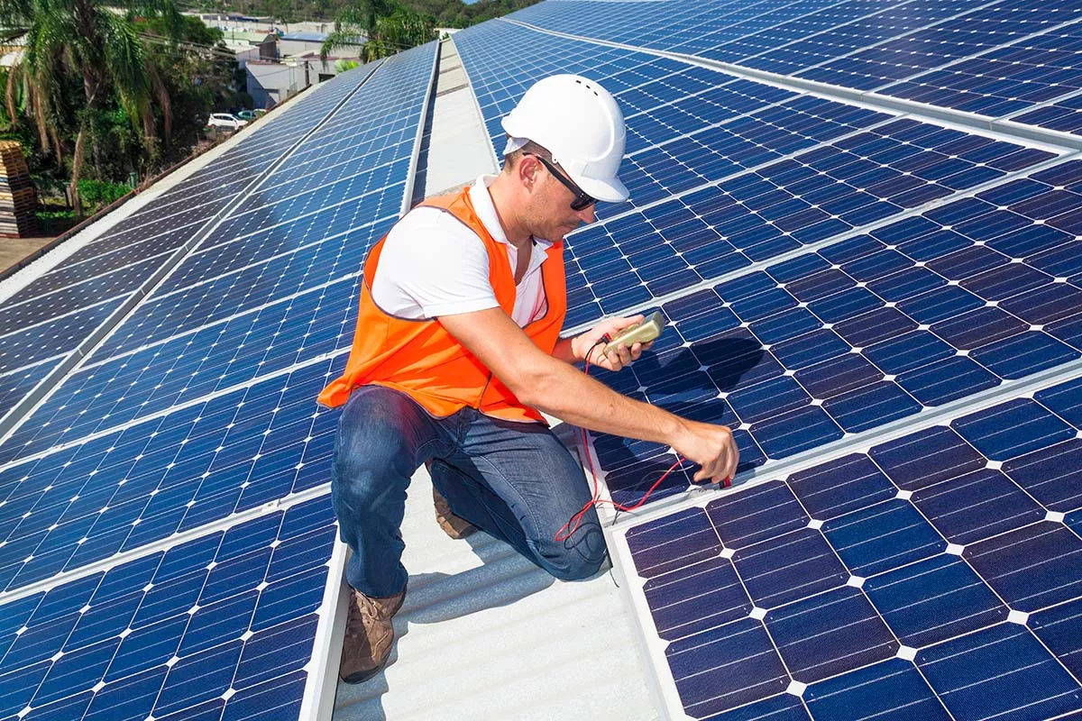 A worker installing Austin solar panels on a rooftop.
