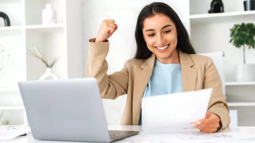 A businesswoman celebrating increased sales and traffic thanks to San Marcos SEO consultants.