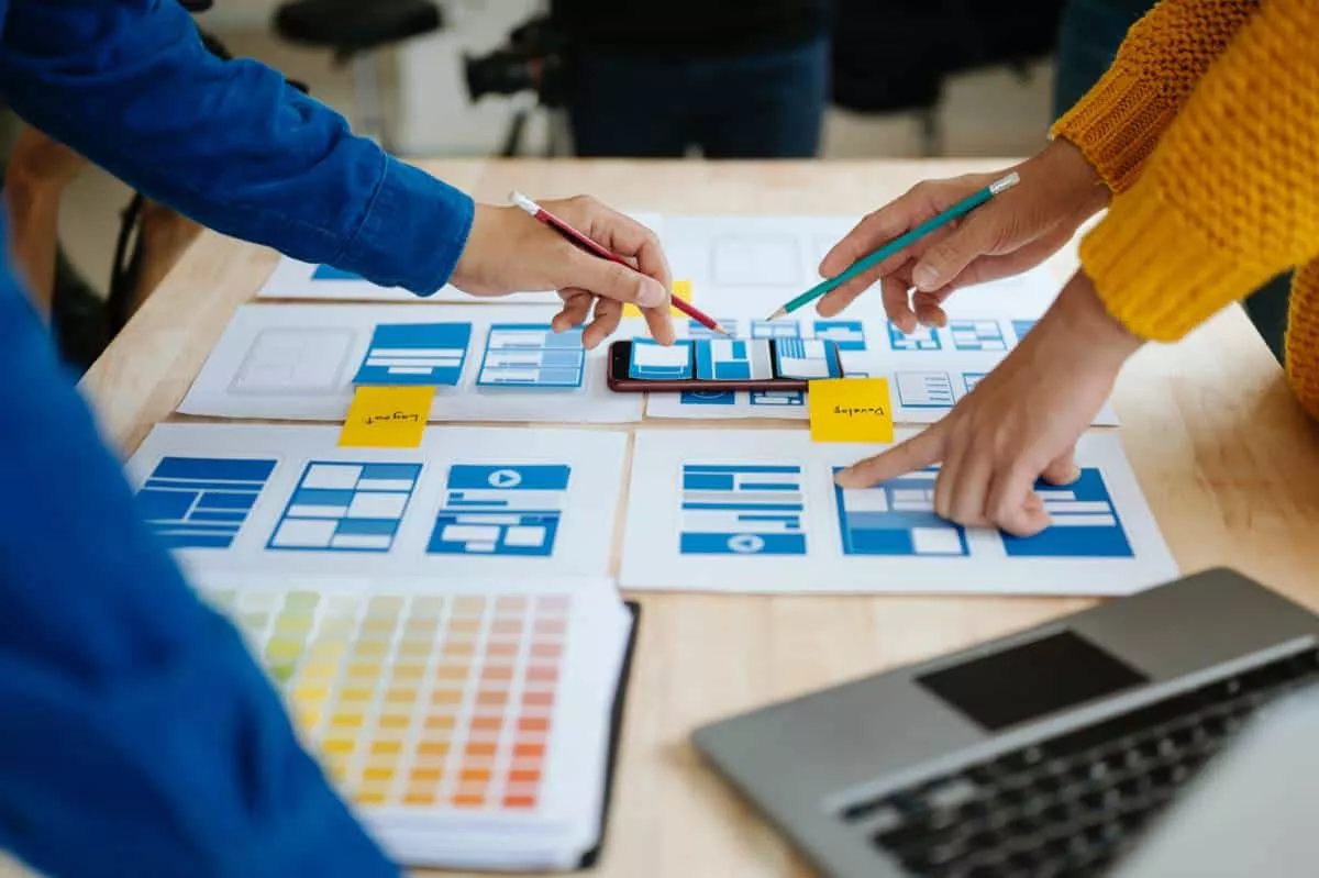 An Austin SEO team working on mobile website design layout at a desk.