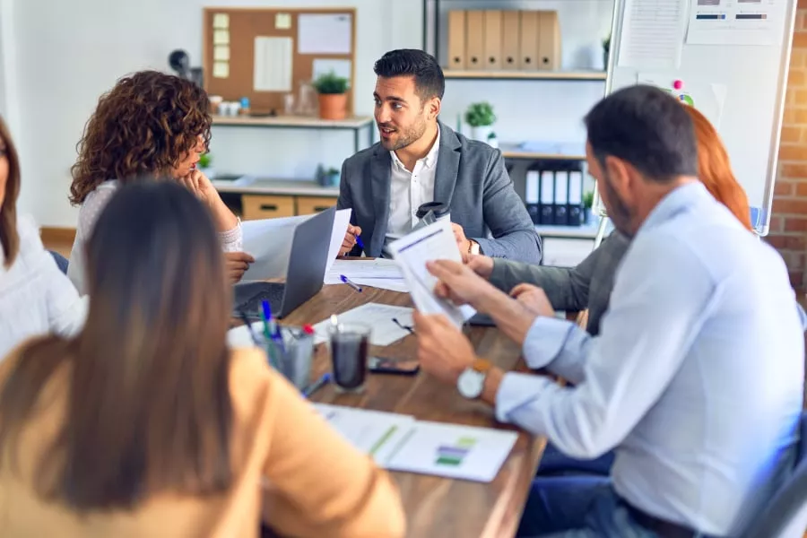 Business team discussing Austin managed IT services in a modern office.