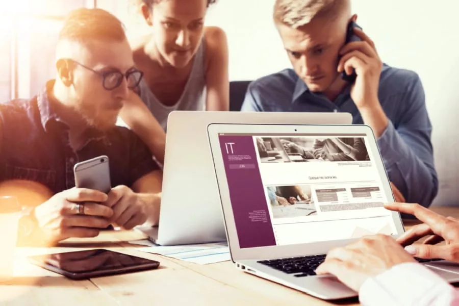 Team discussing San Antonio business continuity strategies on laptops.