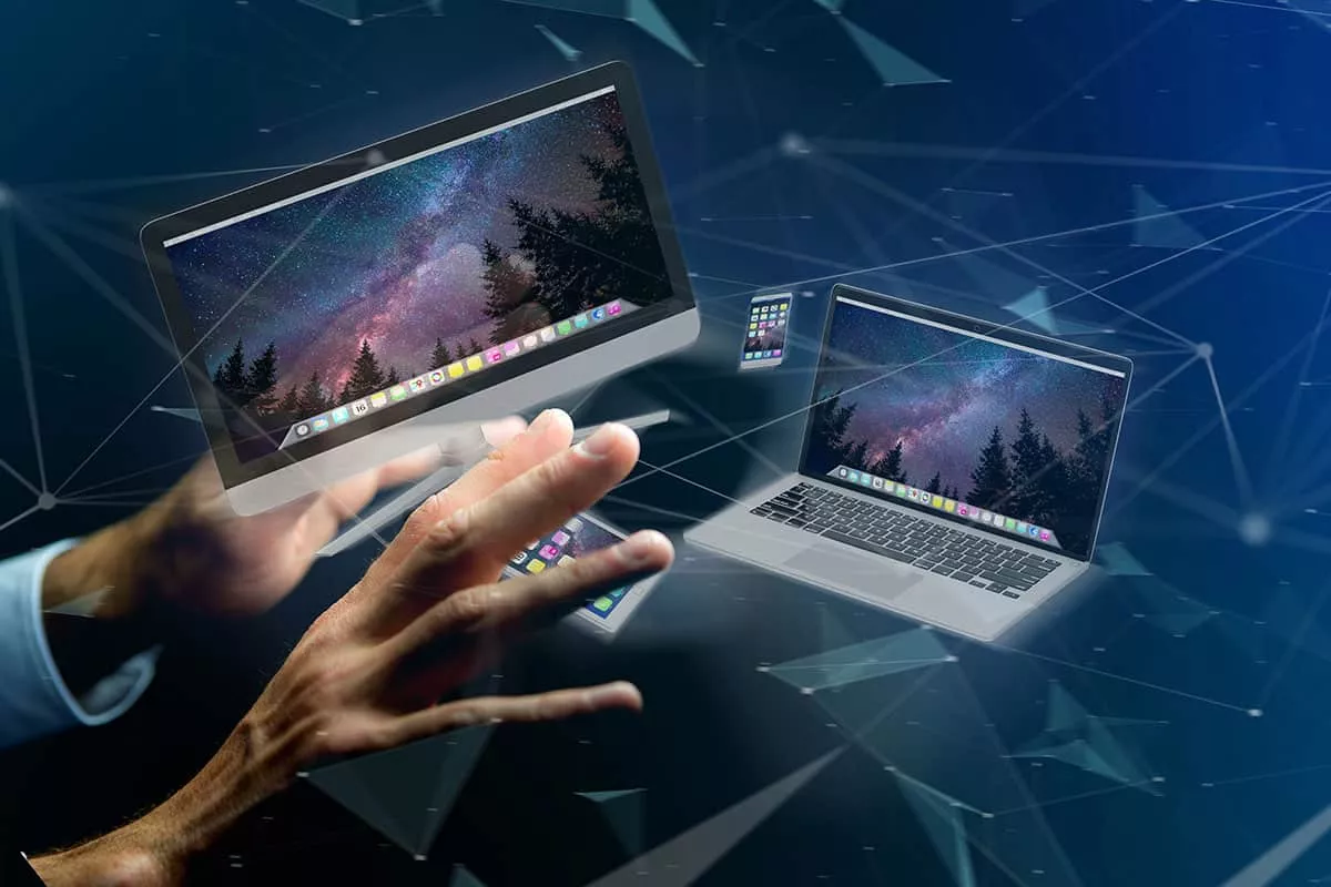 A futuristic digital illustration featuring a hand reaching toward multiple floating computer screens displaying a starry night sky, with geometric lines and shapes representing connectivity and technology.