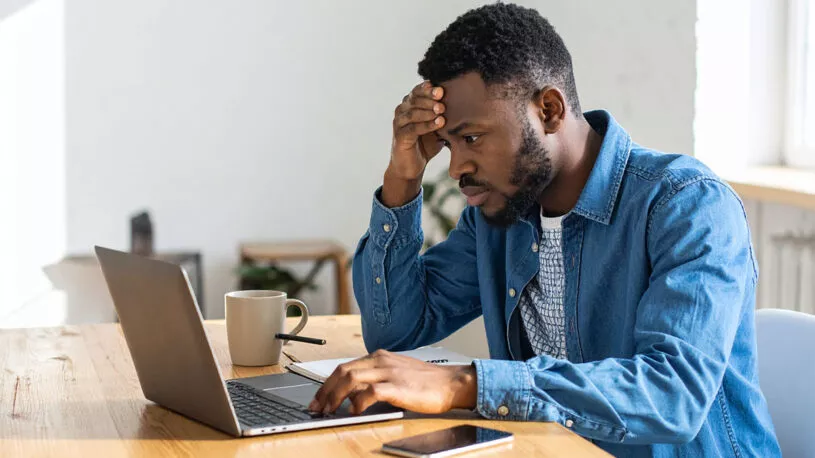 A man stressed over a computer issue in need of Bastrop IT support.
