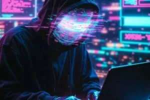 A person in a hoodie sits at a laptop in a dark room filled with neon lights, symbolizing cybersecurity and digital threats.