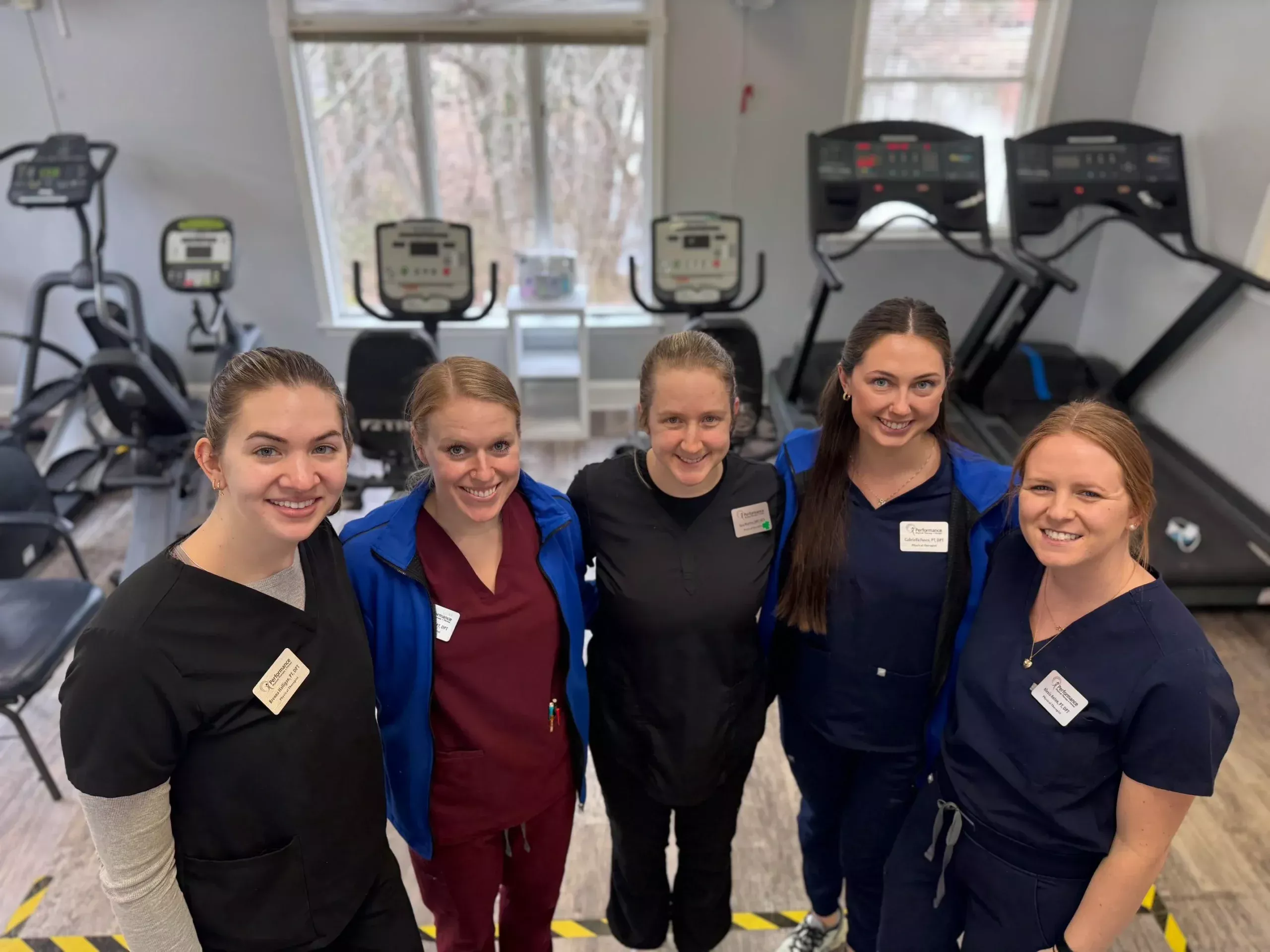 Group of staff in scrubs at a fitness center.