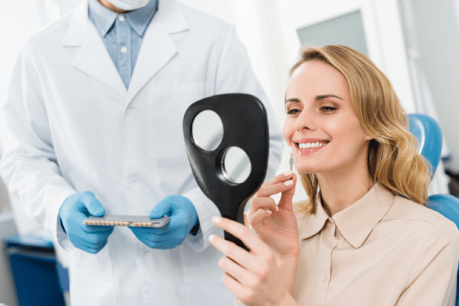 The Life-Changing Benefits of Dental Implants for Tooth Replacement 4 Woman choosing a dental implant looking at the mirror in a dental clinic.