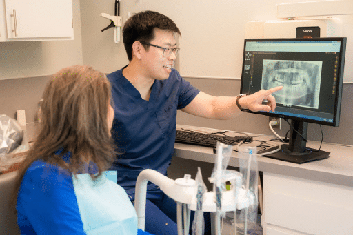 The Importance of Regular Dental Exams for Oral Health Maintenance 4 Dentist explaining x-ray result to patient.