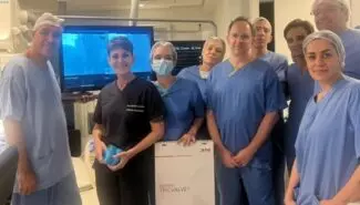 medical team standing with TricValve sign after 100th implant