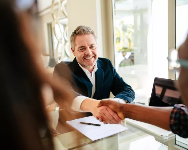 real estate agent shaking hands negotiating