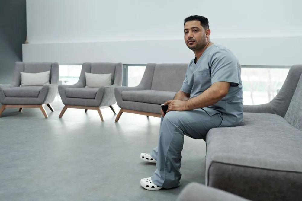 Botox for Chronic Migraines in Grand Prairie, TX 4 Relaxed patient sitting comfortably in a pain management clinic waiting area