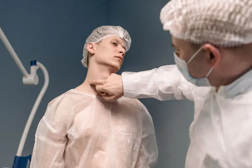 Botox for Chronic Migraines in Plano, TX | Same-Week Consults 1 Doctor examining patient neck pain during chronic migraine consultation in pain clinic
