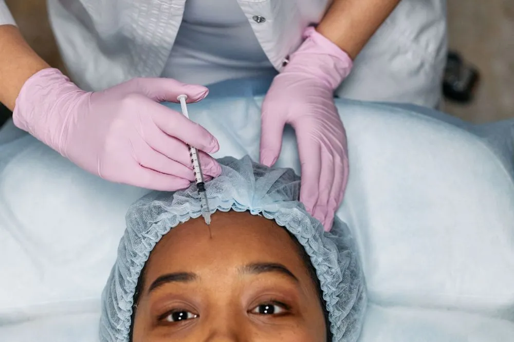Botox for Chronic Migraines in Plano, TX | Relief Guide 2 Medical professional administering Botox injection to forehead for migraine prevention