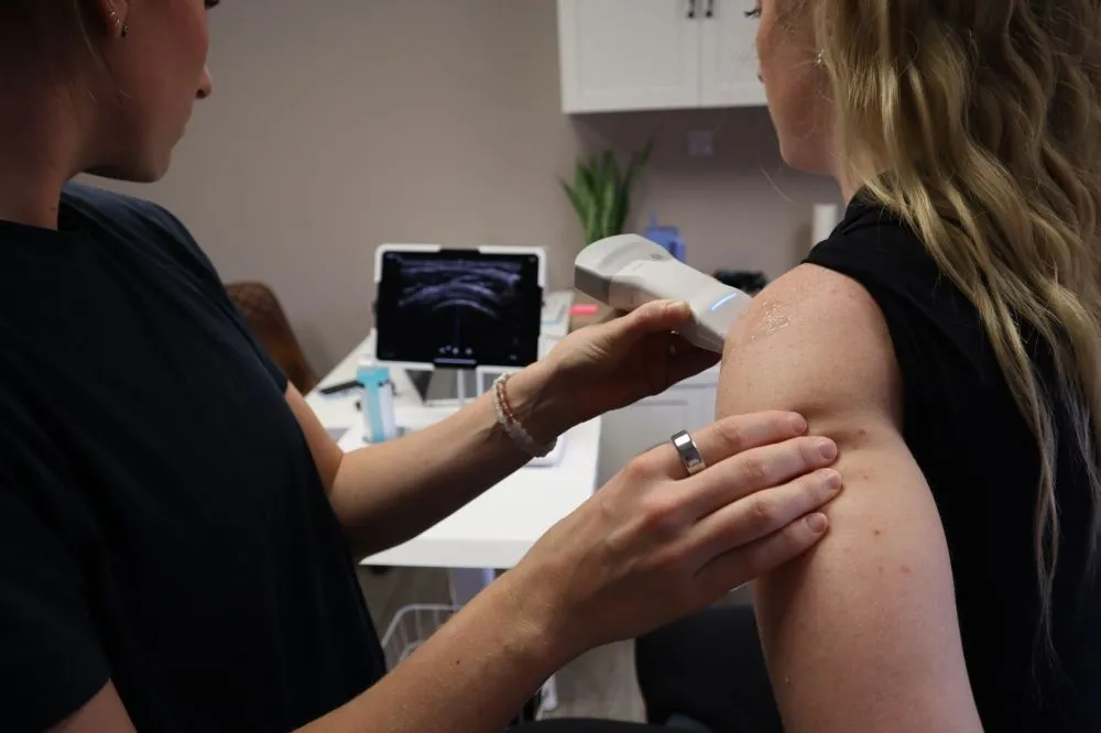 Botox for Chronic Migraines in Plano, TX 1 Physical therapist administering shockwave therapy for chronic musculoskeletal pain