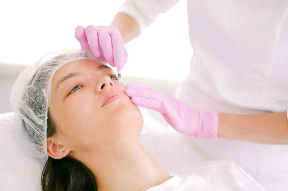 Botox for Chronic Migraines in Plano, TX 3 Medical professional performing Botox injection for chronic migraine treatment in clinic