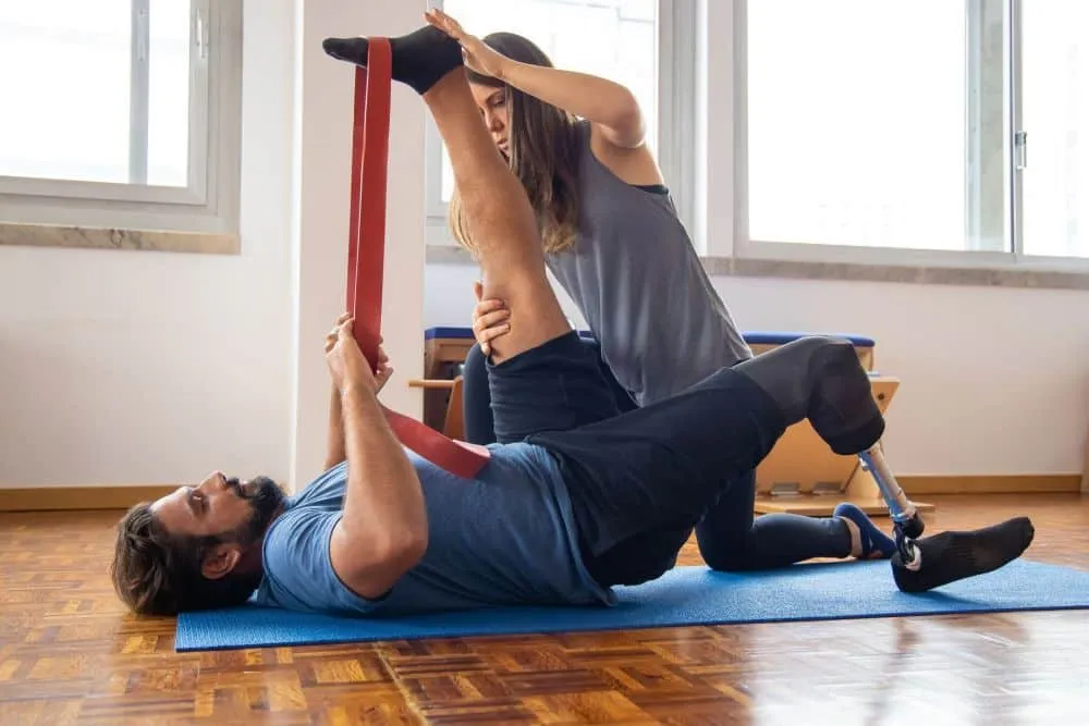 Fibromyalgia & Chronic Pain Management in Plano, TX 2 Physical therapist guiding patient through therapeutic exercises for chronic pain relief