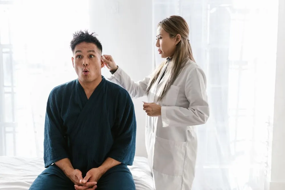 Melatonin & Botox for Chronic Migraines in Grand Prairie, TX 2 Pain specialist consulting a patient about chronic head and neck pain treatment options