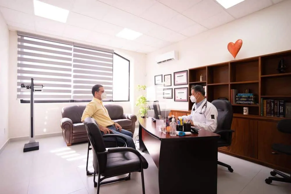 Melatonin for Chronic Pain & Migraines in Tyler, TX 2 Pain management doctor consulting with a patient in a clinical office setting