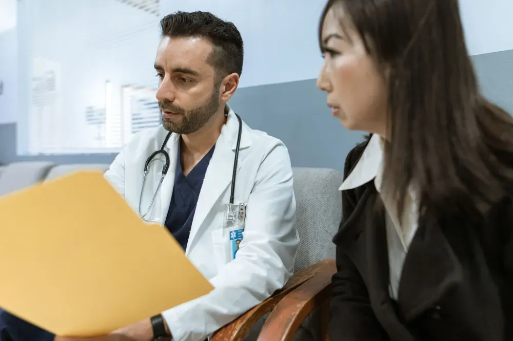 Selective Nerve Root Block in Plano, TX | Non-Surgical Options 4 Pain management doctor reviewing a treatment plan with a patient for radiating arm or leg pain