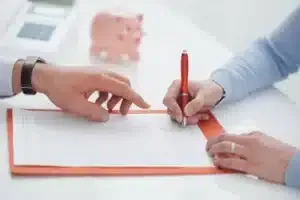 woman signing a loan contract