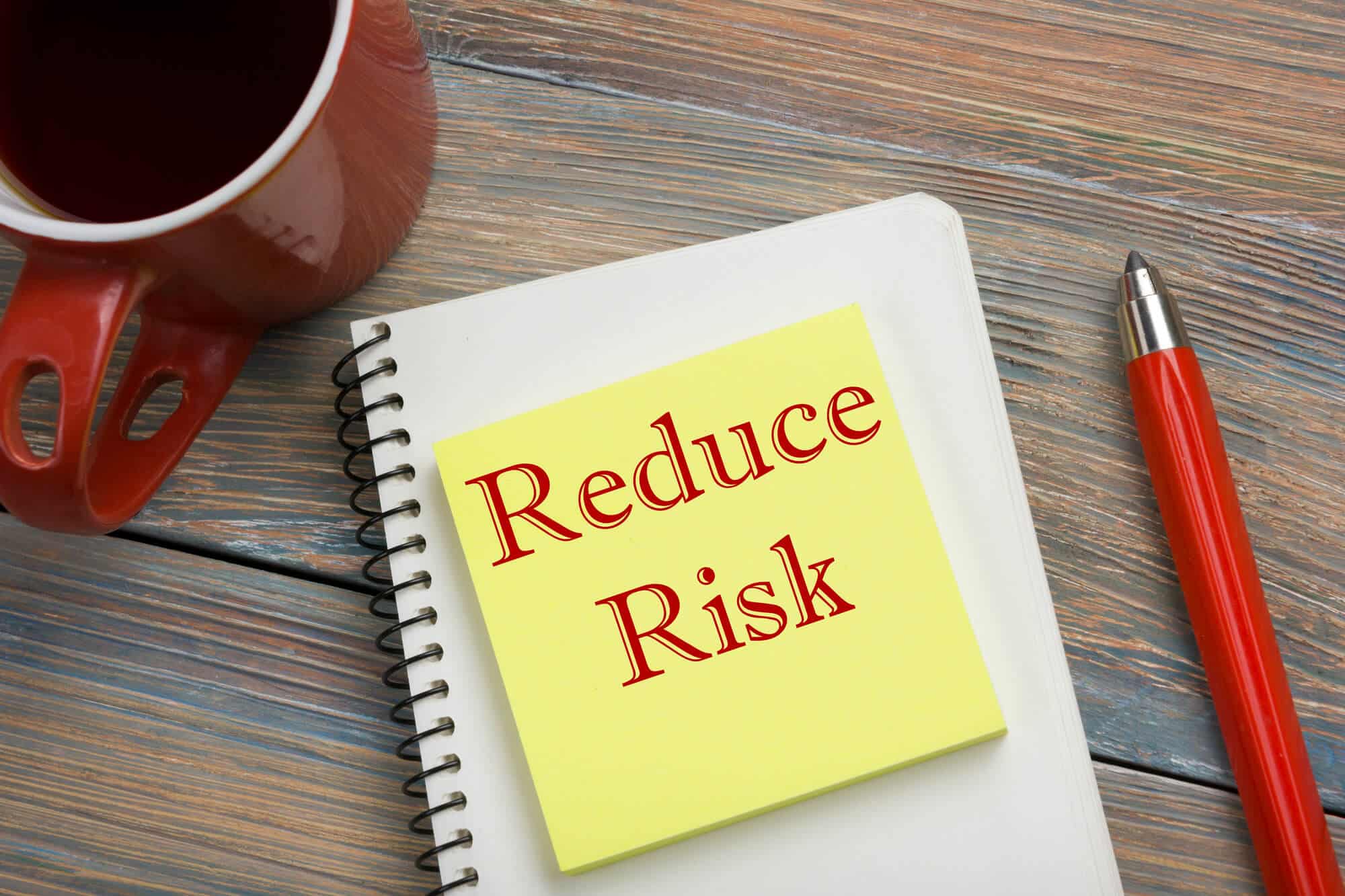 Reduce Risk in a Note on the Table with pen