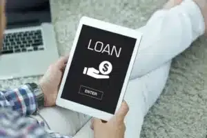 A man holding a tablet with a written text of loan