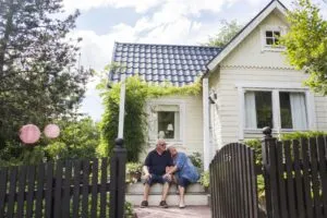 couple sitting on the steps of newly purchased house