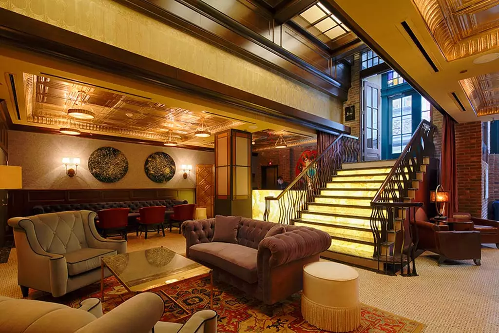 Luxurious lounge with vintage decor and an illuminated staircase.