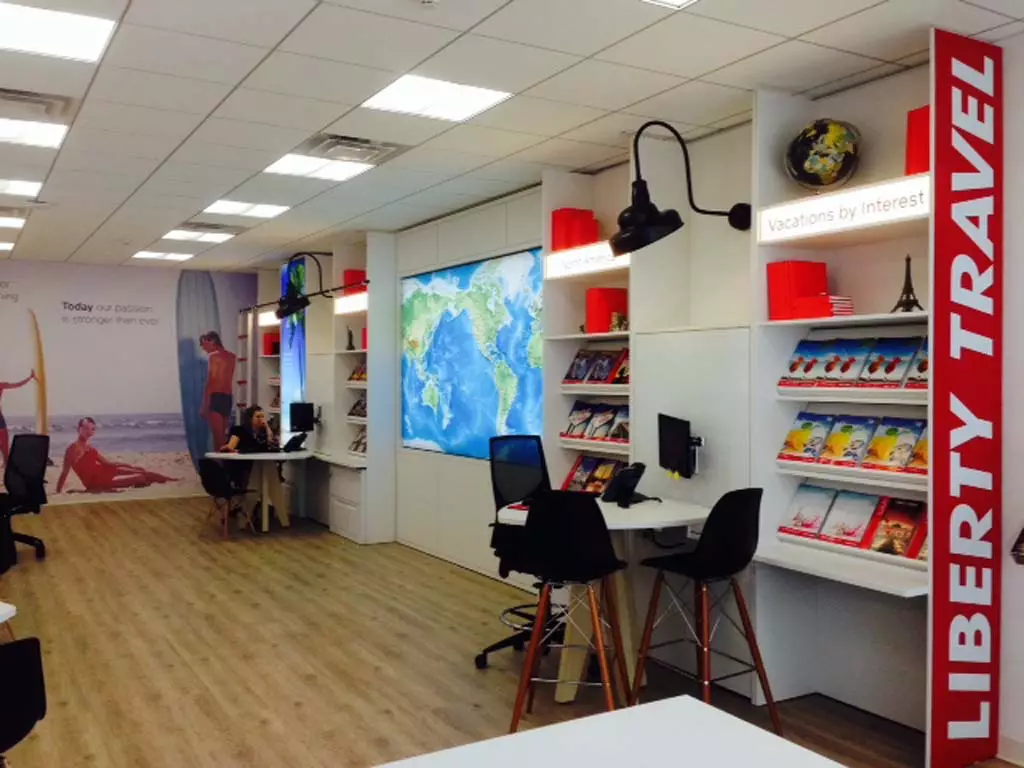 Teen room booths Modern travel agency office with a large world map display and organized brochures.