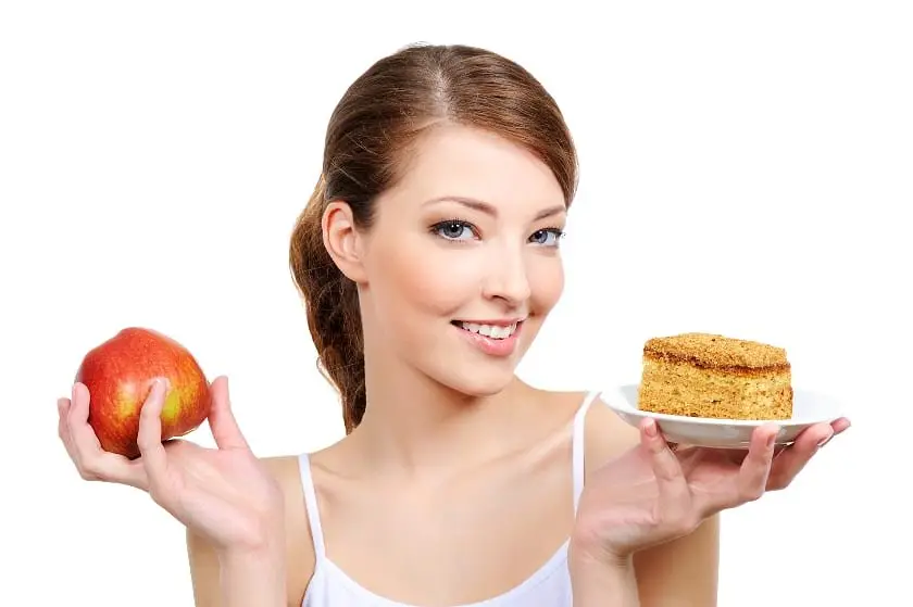 young beautiful girl with fruit and cake in her hands 4 Tips For Getting Past Weight Loss Plateau