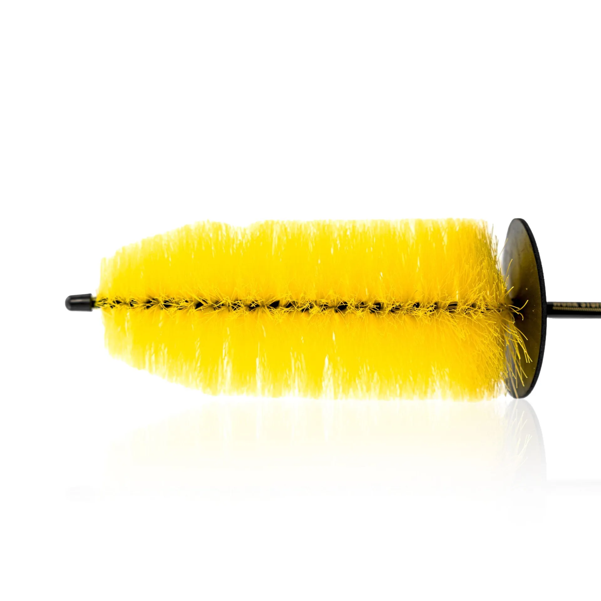 Yellow cylindrical cleaning brush with stiff bristles and black handle, lying horizontally on a white background.