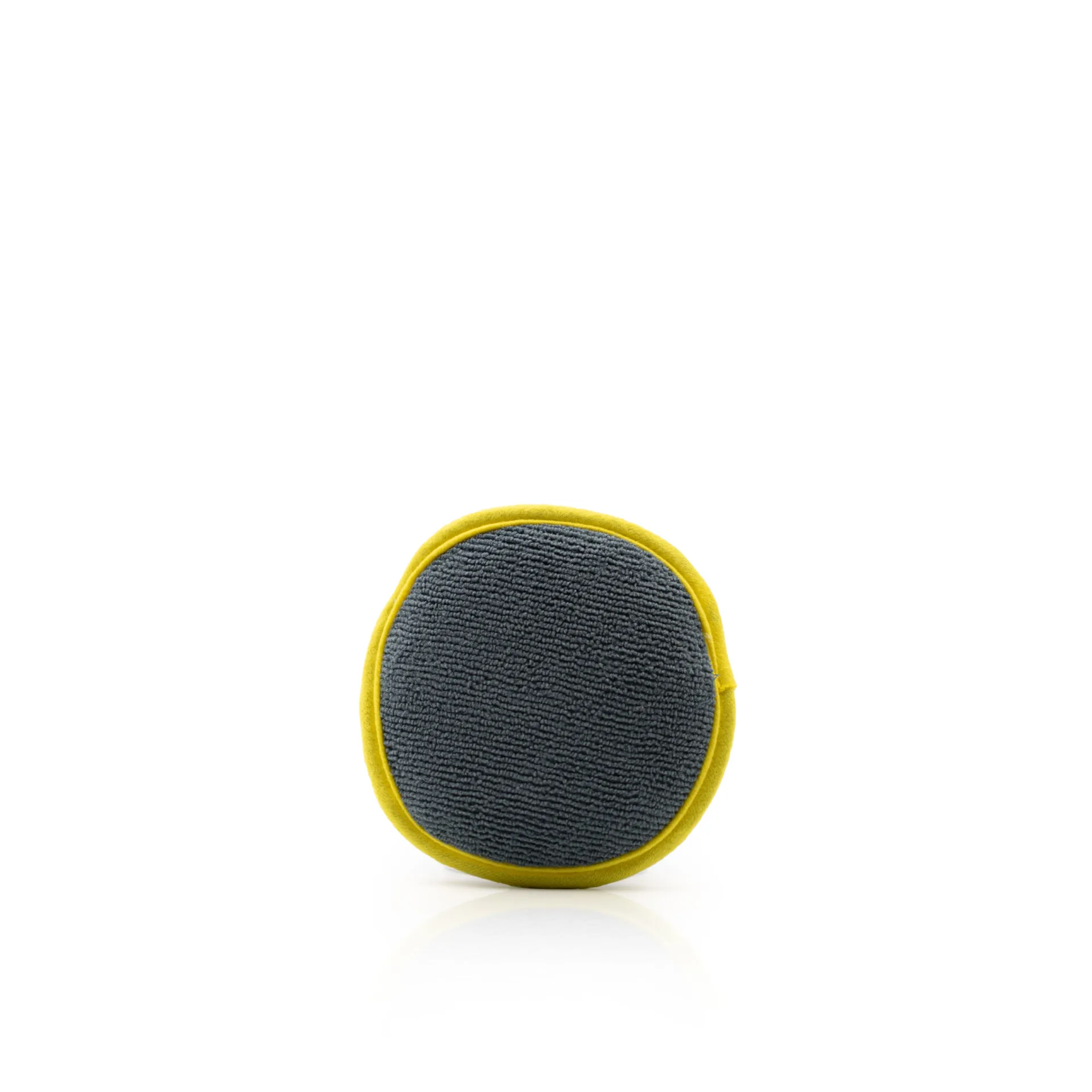 Small, round gray microfiber applicator pad with a yellow border, centered on a plain white background.