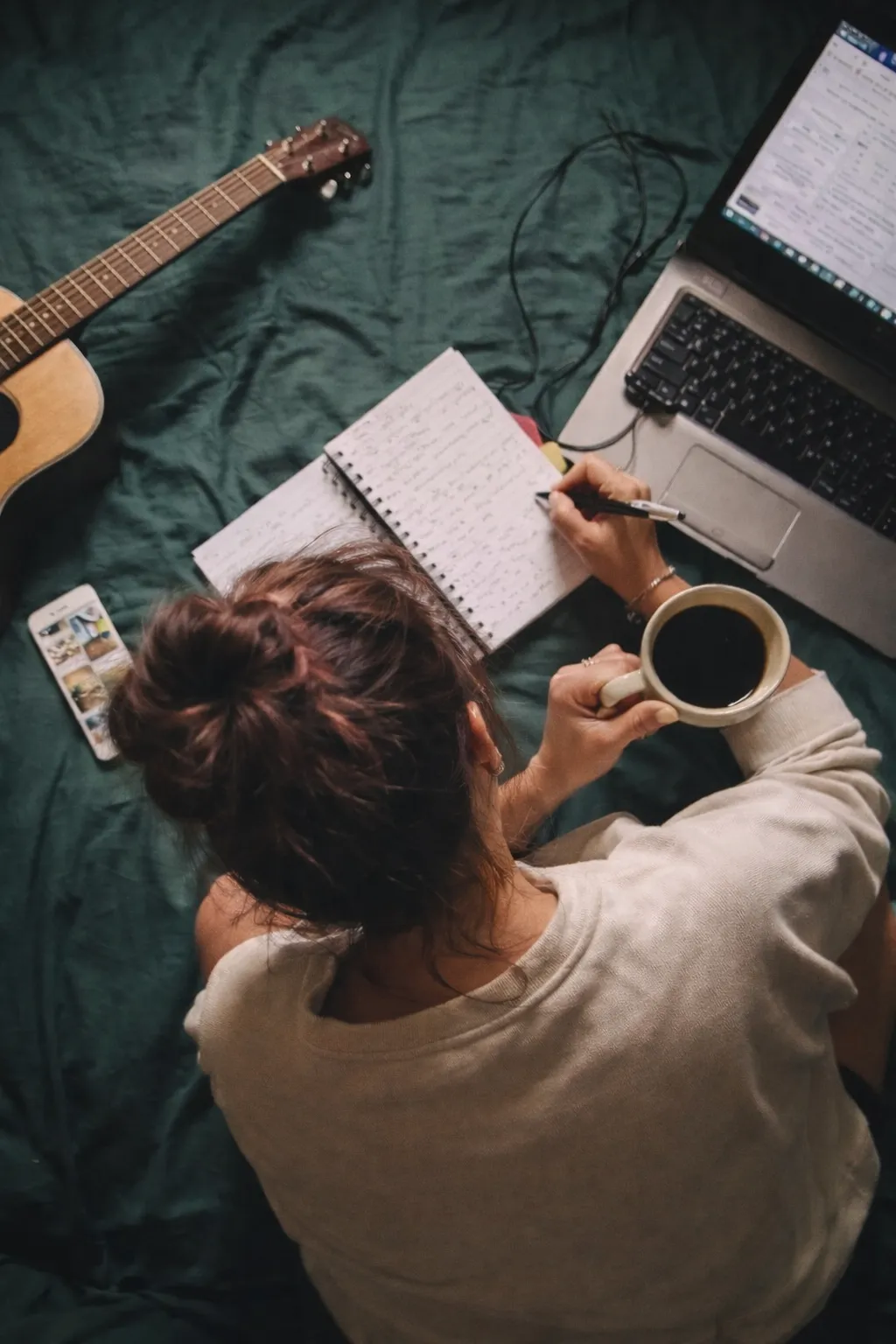 Woman journaling, coffee, guitar, computer