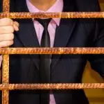 Man in Suit Behind Bars - Virginia Family Law Blog