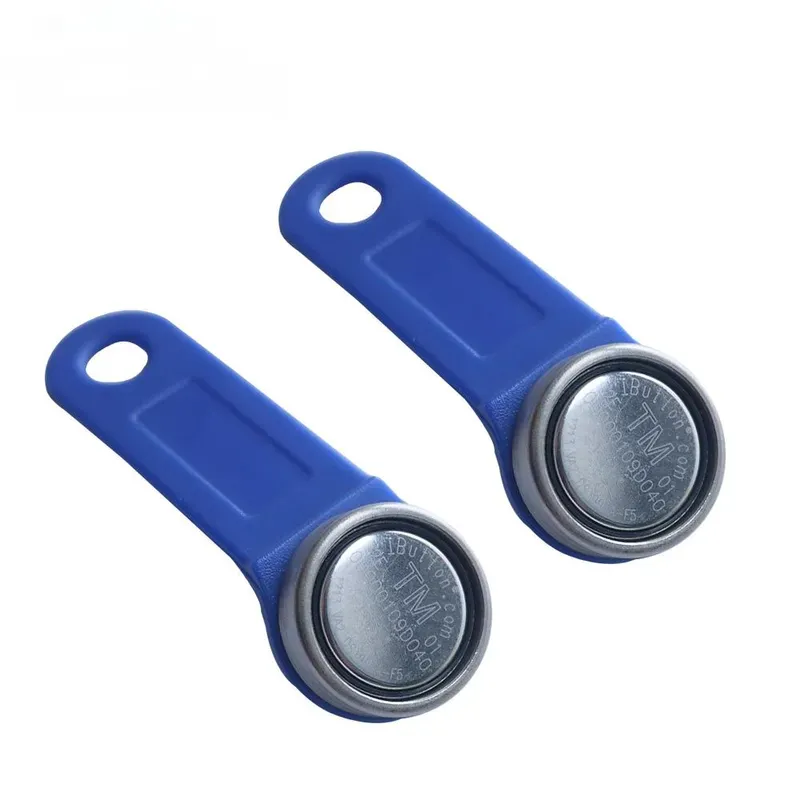 Dhá IButtons Maighnéadacha RFID, ina bhfuil eochairfhabhraí leictreonacha gorma le teagmhálacha ciorclach miotail, a thaispeántar i gcoinne chúlra bán.