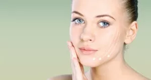 A young woman touches her face and looks at the camera. Three lines are drawn pointing downward on her cheek