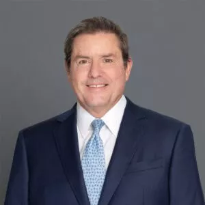 Headshot of Dr. Barnhorst in professional wear with a grey background.