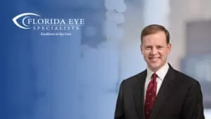 Photo of Dr. Lott with a lit up room behind him. The image has a blue shadow overlay with the Florida Eye Specialists logo in the top left corner.