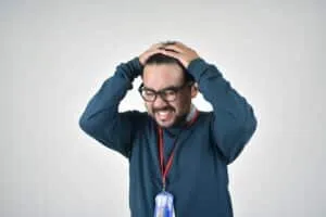 3 Ways to Manage Anger in a Healthy Way 4 picture of a man with glasses; his teeth are clenched in anger and his hands are tugging at his hair