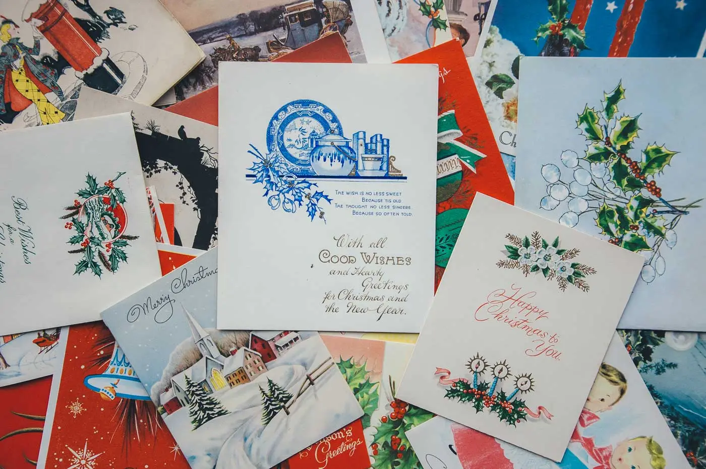 Vintage Christmas cards with festive scenes and holly, styled for cozy Verbier chalet luxury rentals by GuestLee Switzerland. | GuestLee luxury rental Switzerland