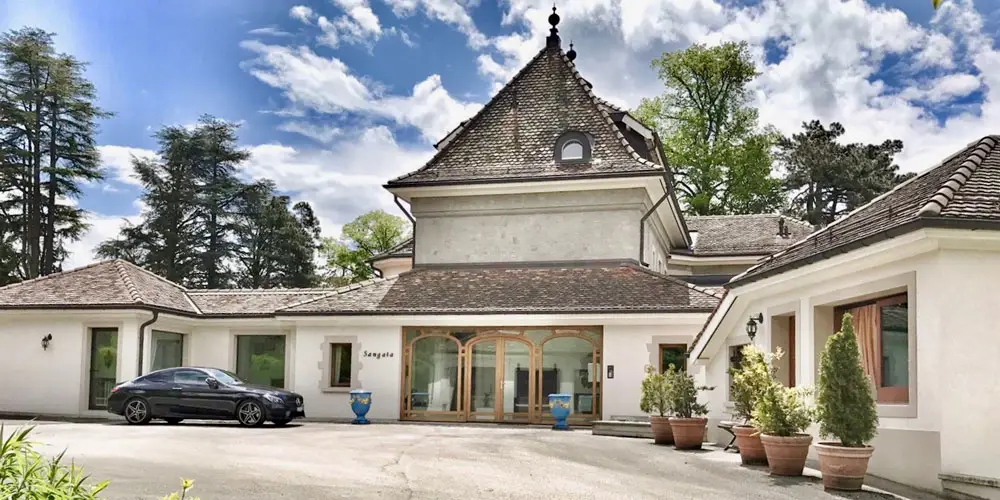 LEE_About_2 Luxury Montreux apartment rental with elegant tiled roof, arched doors, lush greenery, Alps views—GuestLee Swiss property. | GuestLee luxury rental Switzerland