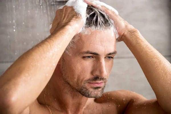 Does Shampoo Cause Hair Loss? man shampooing his hair