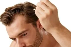PRP vs Topical Finasteride and Minoxidil Combo man using topical hair loss medication