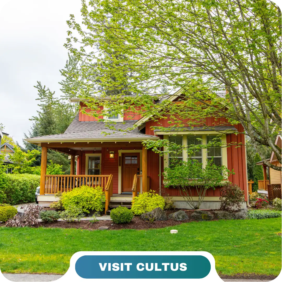 A red house with a covered porch and surrounding green trees and shrubs, set on a neatly maintained lawn. Text at the bottom reads "VISIT CULTUS." Enjoy your stay with Lifty Life.